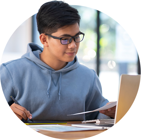 Male student with laptop and papers