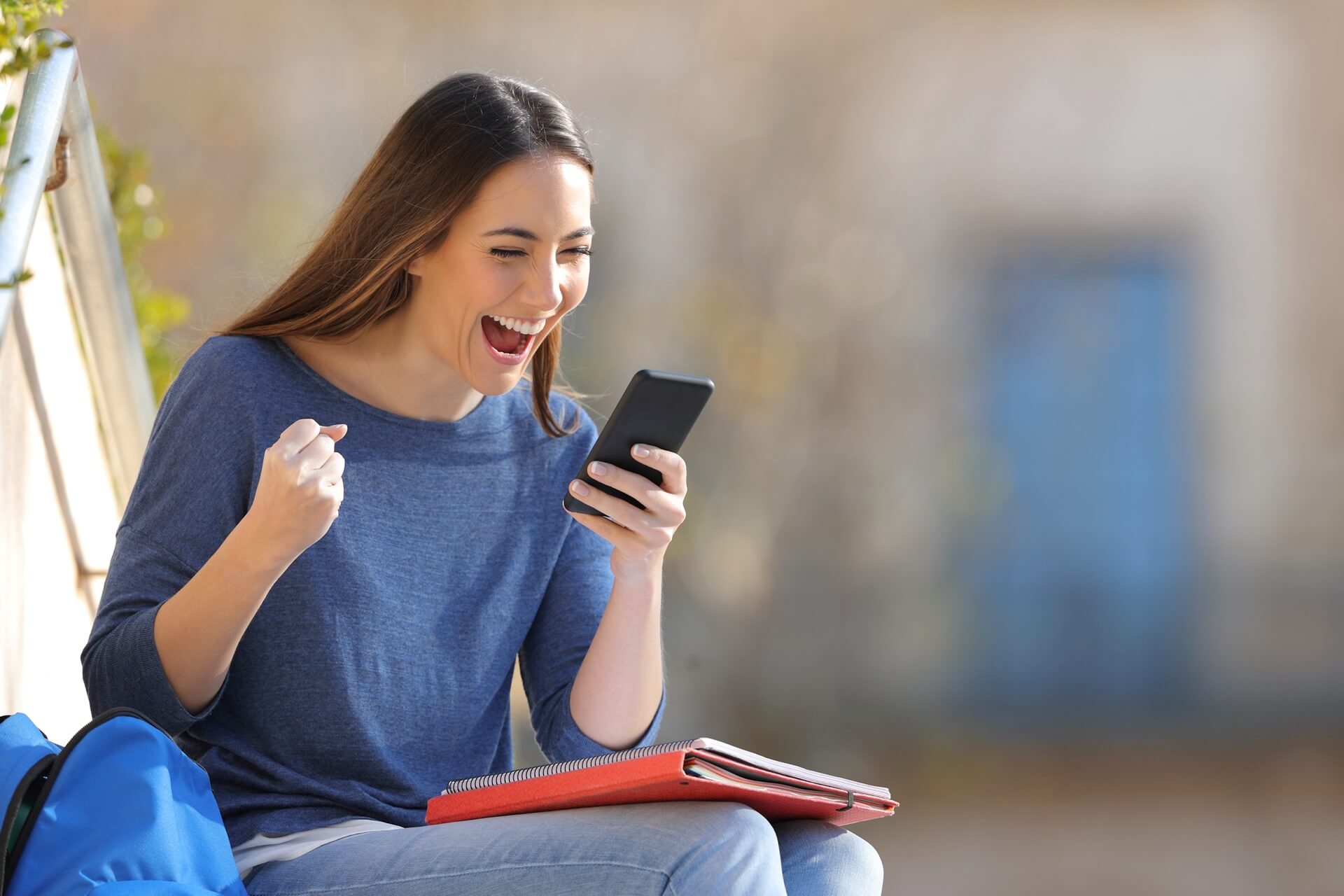 Student happy looking at her phone