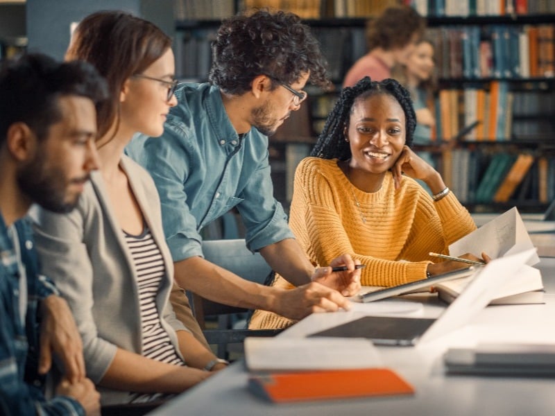 Group of students working together in a library