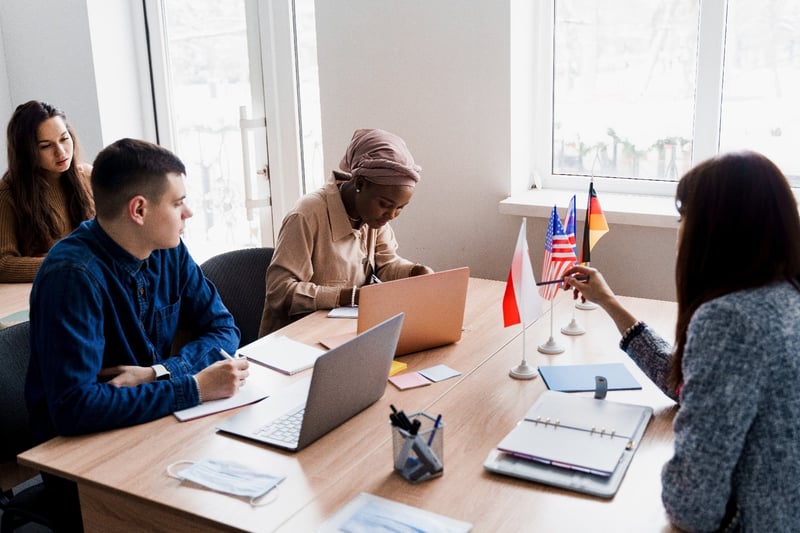 Multiethnic students studying with laptop