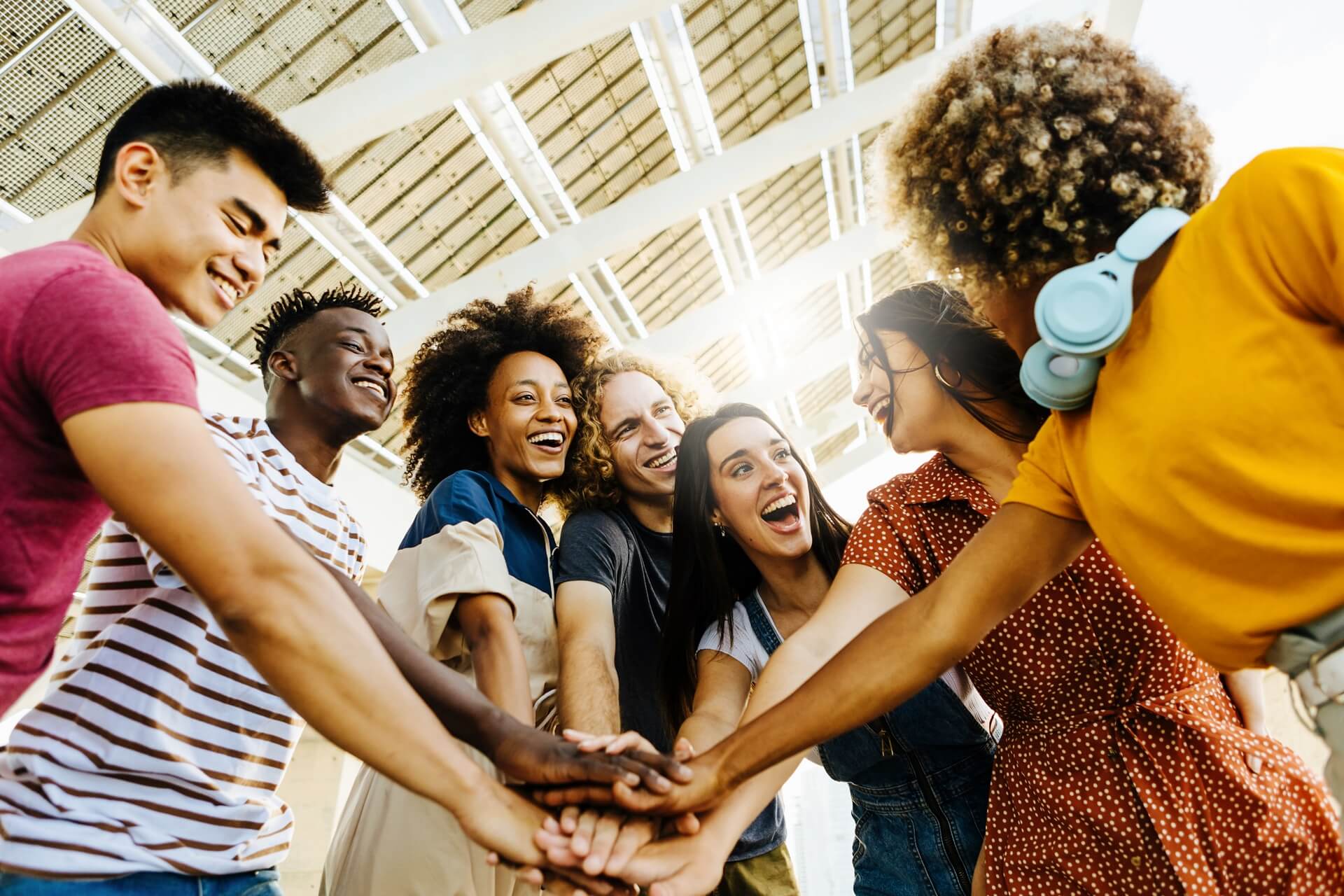 Group of students joining for a high five