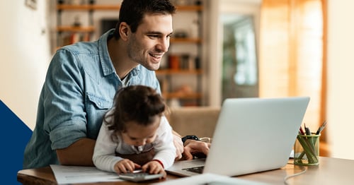 Man and baby working at laptop computer