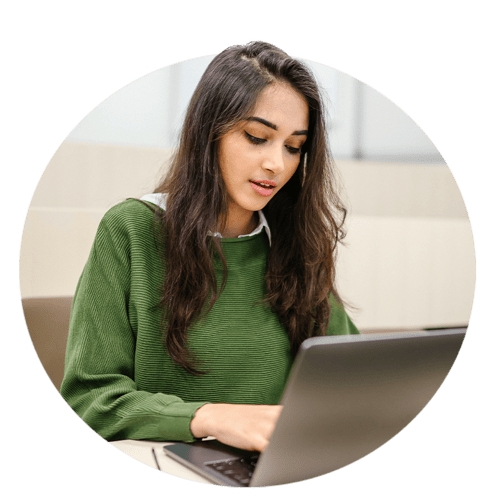 University student with green sweater on computer