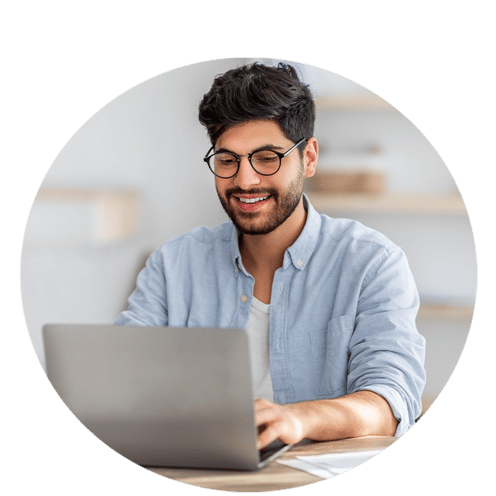 Young man smiling working on a computer