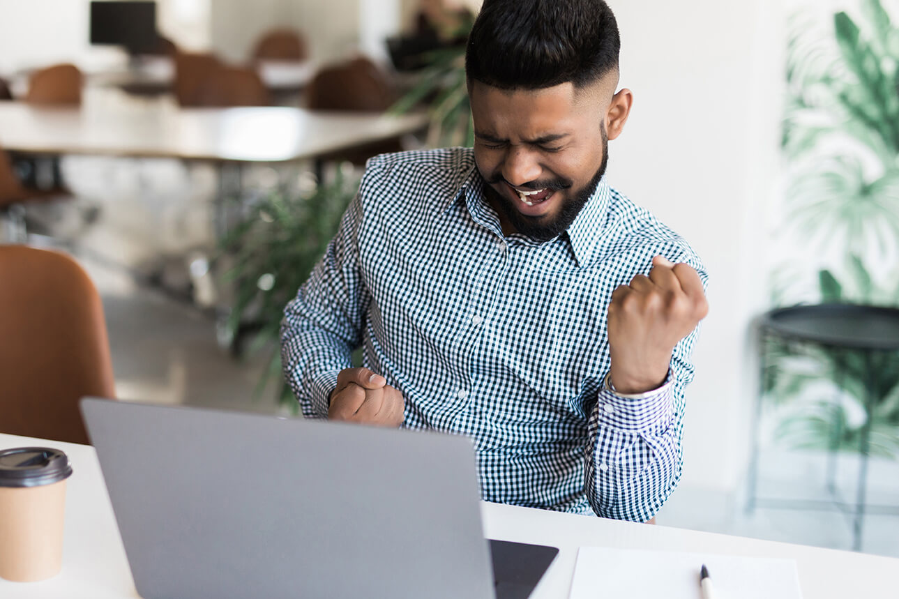 Man celebrating in front of a computer-1