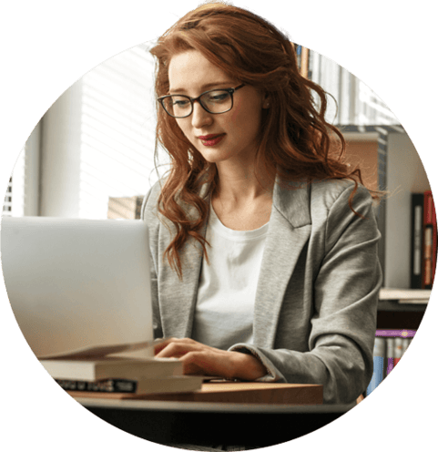 Young woman working on laptop in library